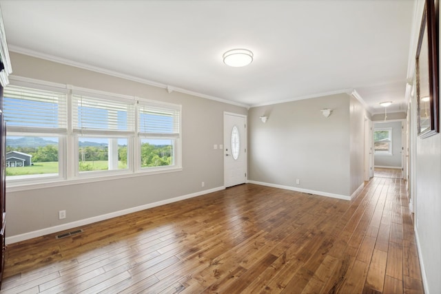 unfurnished room with hardwood / wood-style floors and ornamental molding