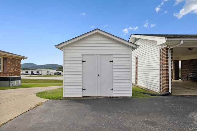 view of outbuilding with a mountain view and a carport