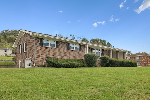 view of front of home featuring a garage and a front lawn