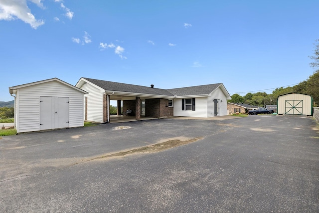 view of front of house featuring a storage unit