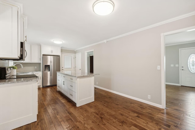 kitchen with white cabinetry, stainless steel fridge with ice dispenser, a center island, and light stone countertops