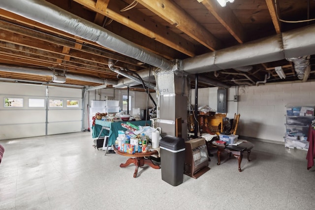 garage with a garage door opener and electric panel