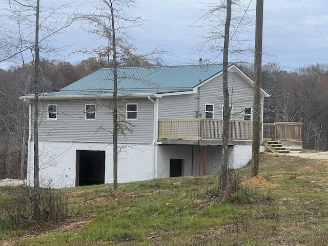 rear view of property featuring a deck