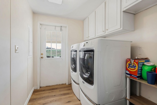 washroom featuring light hardwood / wood-style flooring, cabinets, and independent washer and dryer