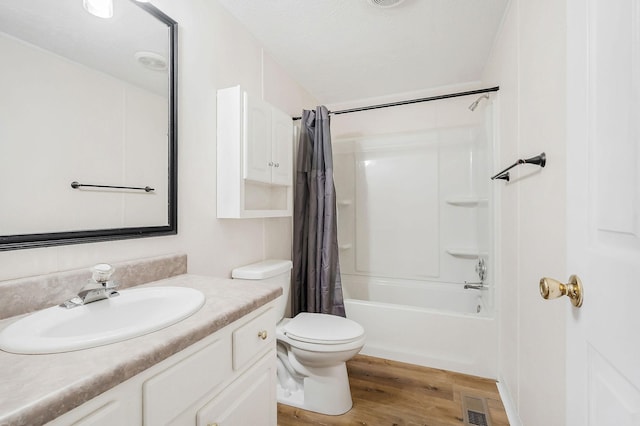 full bathroom featuring hardwood / wood-style flooring, vanity, toilet, and shower / bathtub combination with curtain