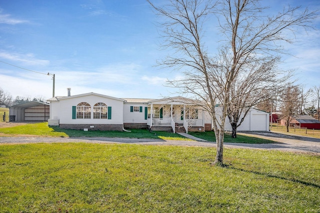 view of front facade featuring covered porch, a front lawn, a garage, and a carport