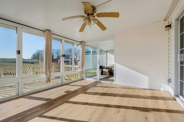 unfurnished sunroom with ceiling fan and a wealth of natural light