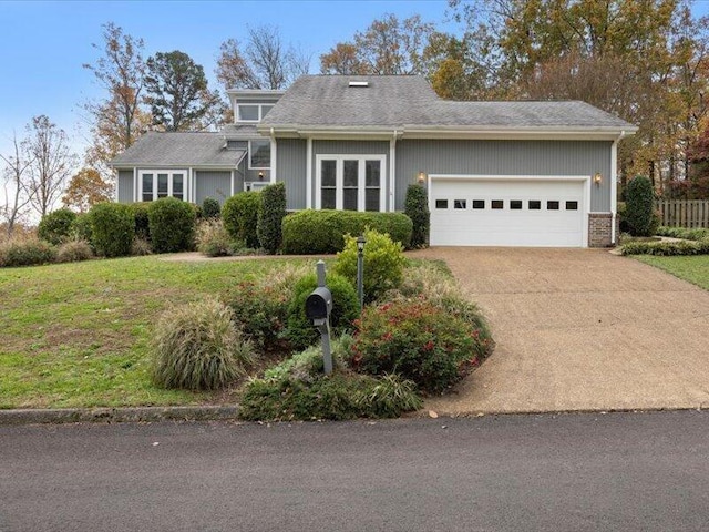 view of front of property featuring a garage and a front lawn