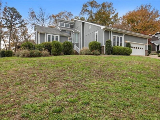 view of front of house with a garage and a front lawn