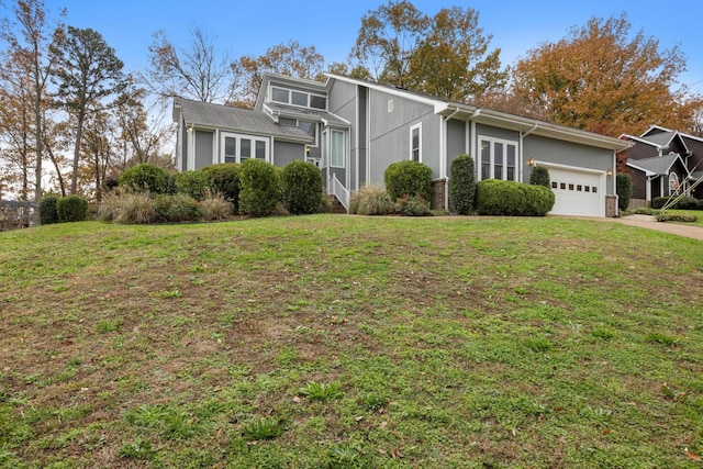 view of front facade with a garage, driveway, and a front lawn