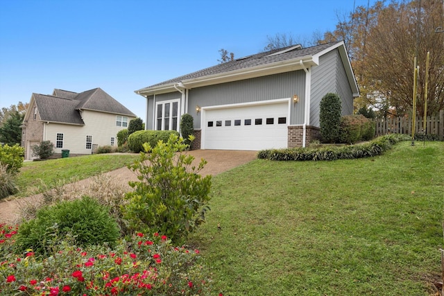 view of front of property with a front yard, brick siding, and an attached garage