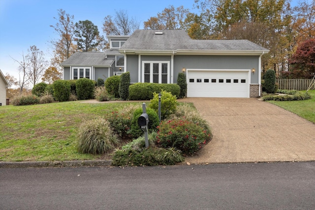 view of front of property featuring a garage, driveway, a front lawn, and brick siding