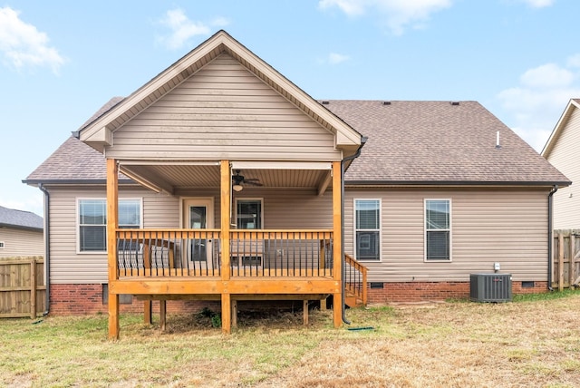 rear view of property featuring a deck, ceiling fan, a lawn, and central air condition unit