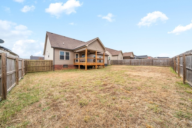 rear view of property with a deck and a lawn