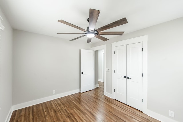 unfurnished bedroom with ceiling fan, wood-type flooring, and a closet