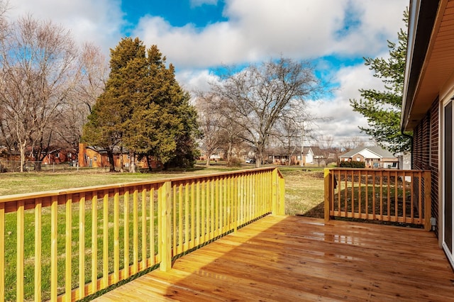 wooden deck featuring a lawn