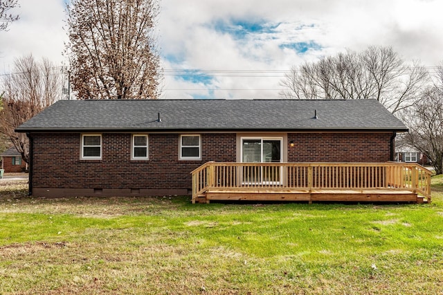 back of house with a wooden deck and a lawn