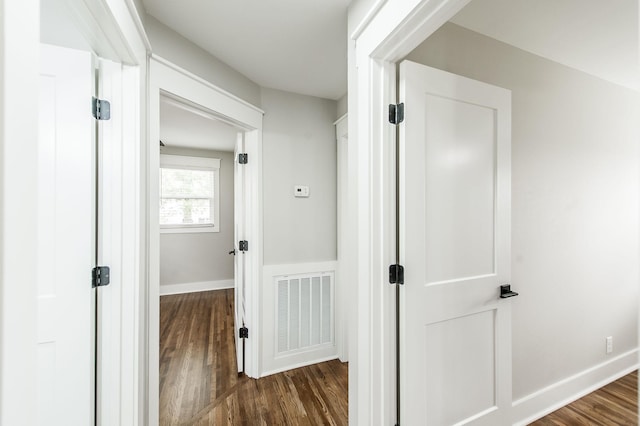 hall with dark hardwood / wood-style floors