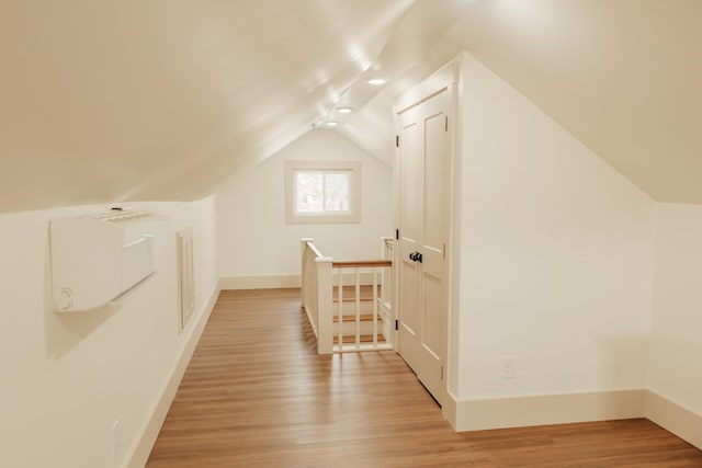 bonus room featuring light hardwood / wood-style floors and lofted ceiling