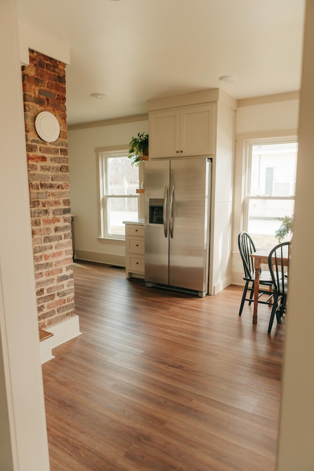 kitchen featuring stainless steel fridge and light hardwood / wood-style flooring