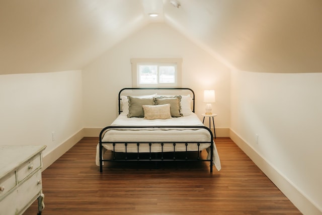 bedroom featuring hardwood / wood-style floors and lofted ceiling