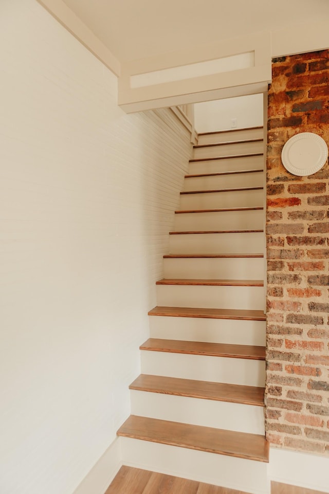 stairway featuring wood-type flooring