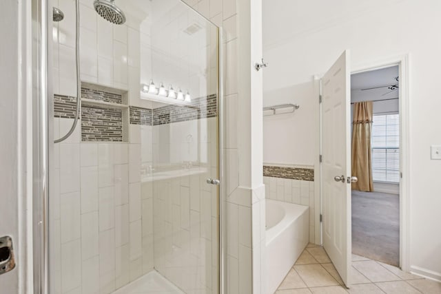 bathroom featuring tile patterned flooring and shower with separate bathtub