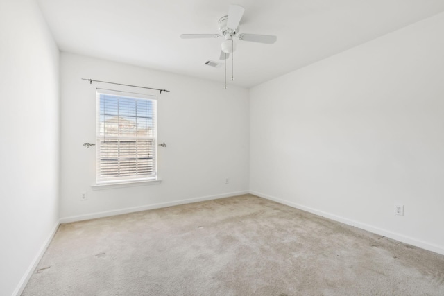 unfurnished room with ceiling fan and light colored carpet