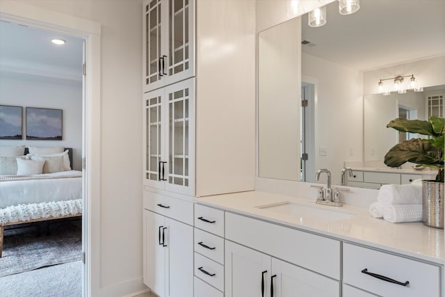 bathroom with recessed lighting, visible vents, ensuite bathroom, vanity, and baseboards