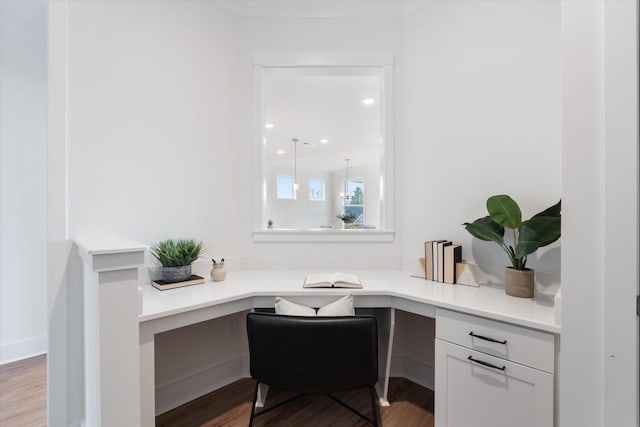 office featuring hardwood / wood-style floors and built in desk