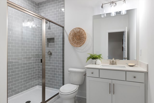 full bathroom featuring a stall shower, vanity, toilet, and baseboards