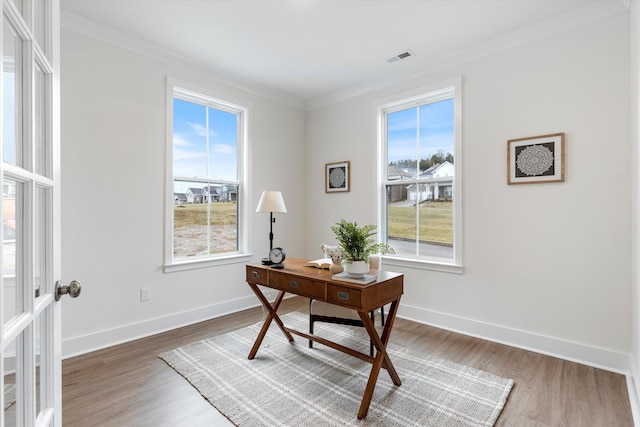 office space featuring ornamental molding, wood finished floors, visible vents, and baseboards