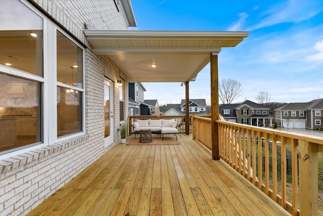 wooden deck featuring a residential view and an outdoor living space