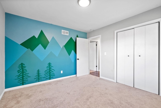 unfurnished bedroom featuring carpet floors and a closet