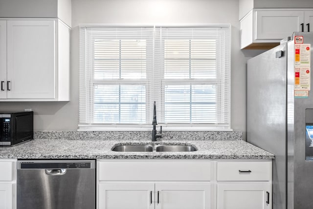 kitchen featuring white cabinets, stainless steel appliances, and sink