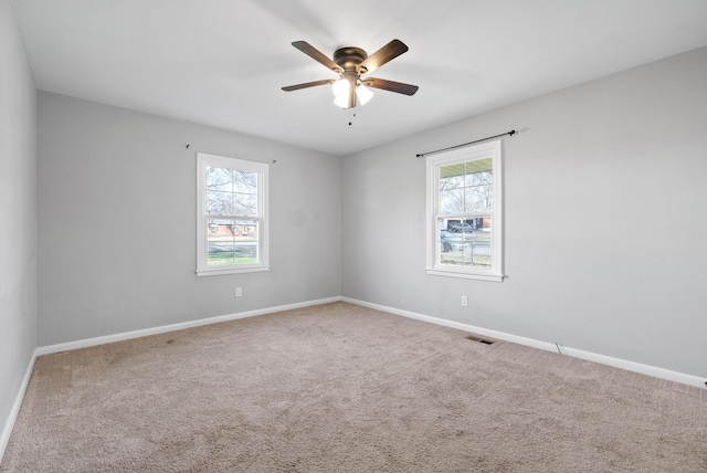 unfurnished room featuring carpet floors, ceiling fan, and a healthy amount of sunlight