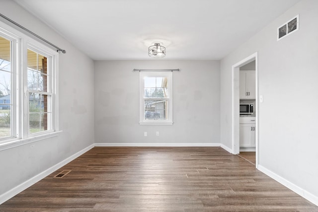 unfurnished room featuring hardwood / wood-style floors and plenty of natural light