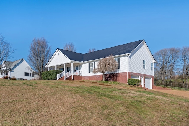 view of front of house with a porch, a garage, and a front yard