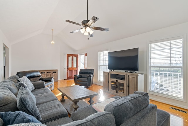 living room with light wood-type flooring, ceiling fan, and lofted ceiling