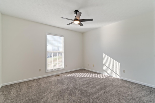 carpeted spare room featuring ceiling fan