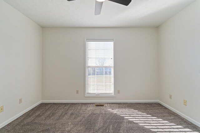 carpeted spare room with ceiling fan