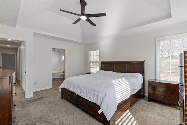 carpeted bedroom featuring connected bathroom, a raised ceiling, ceiling fan, and crown molding