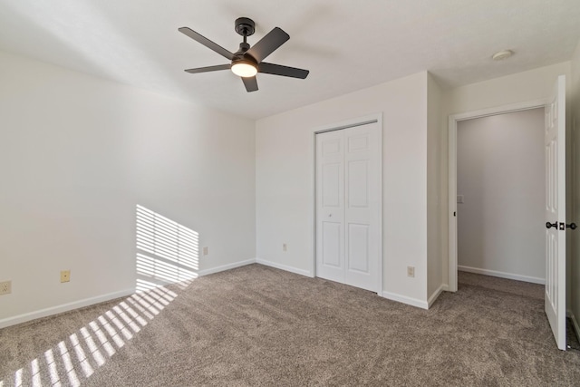 unfurnished bedroom featuring ceiling fan, light colored carpet, and a closet