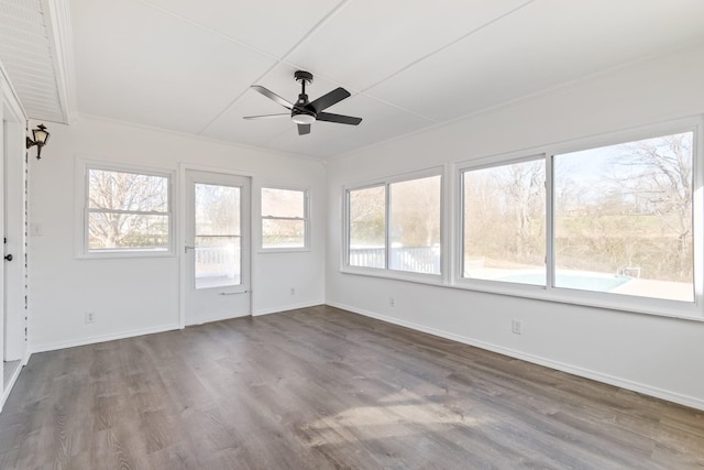 unfurnished sunroom featuring ceiling fan