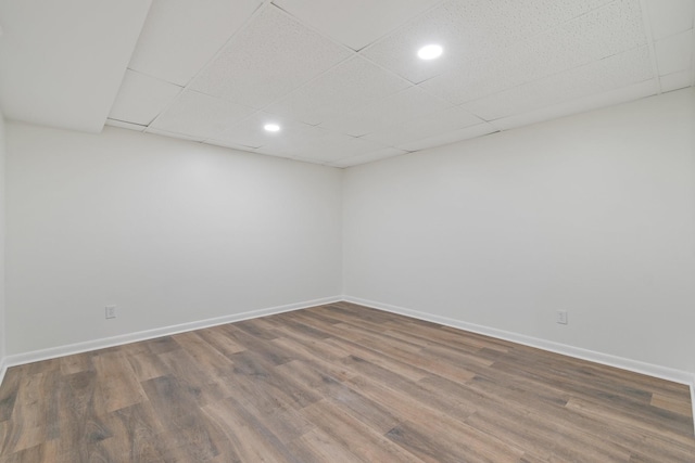 unfurnished room featuring a paneled ceiling and wood-type flooring