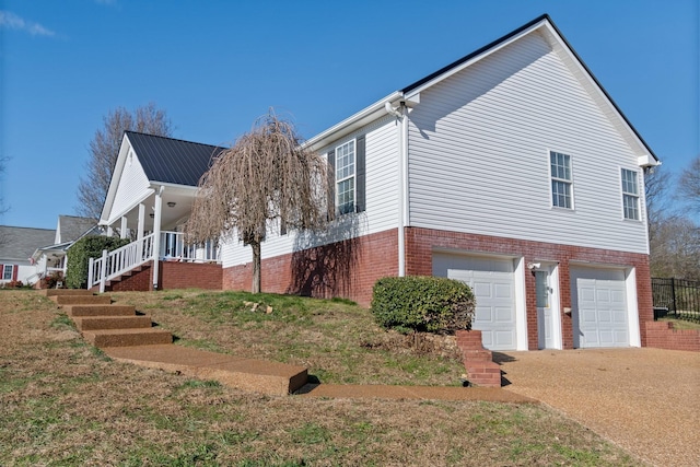 view of property exterior featuring covered porch and a garage