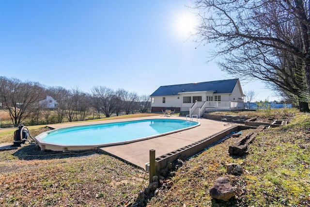 view of swimming pool with a deck