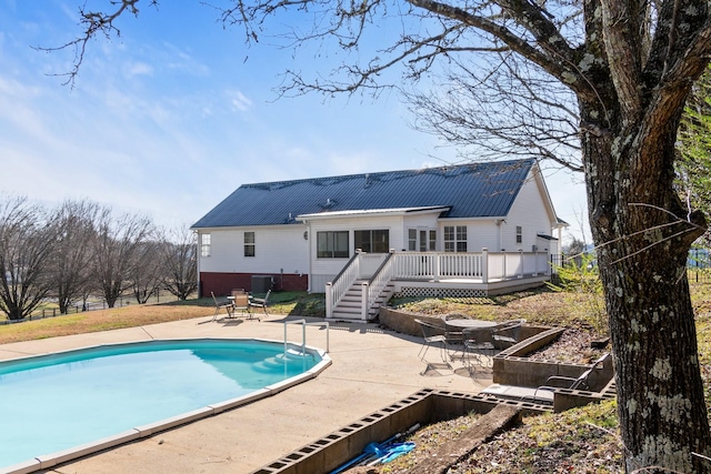 back of house featuring a pool side deck, a patio area, and central air condition unit