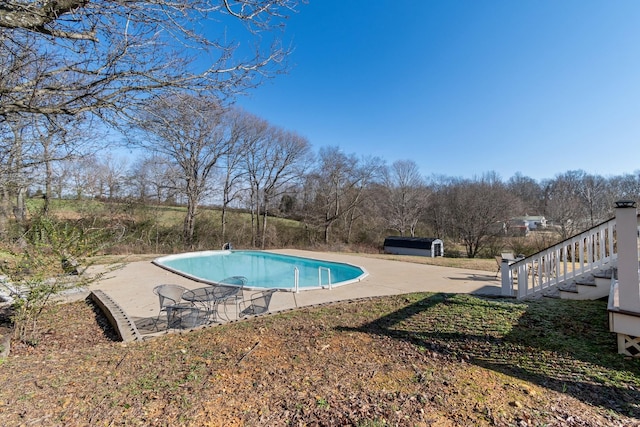 view of swimming pool with a patio area