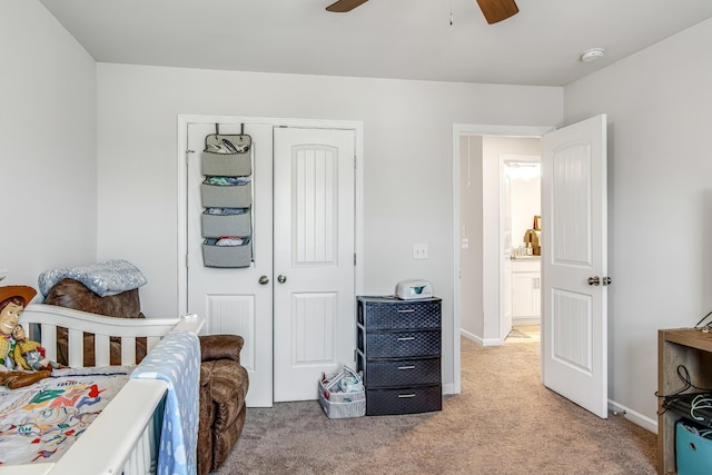 carpeted bedroom featuring a closet and ceiling fan